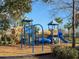 Close-up of a colorful playground with slides, climbing features, and various play structures at 4734 Chatterton Way, Riverview, FL 33578