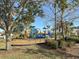 Community playground with slides, climbing structures, and swings amidst lush greenery at 4734 Chatterton Way, Riverview, FL 33578