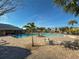 Resort-style pool with comfortable seating, a shaded cabana, and palm trees, perfect for relaxation and enjoyment at 4734 Chatterton Way, Riverview, FL 33578
