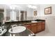 Bathroom featuring a large vanity with dual sinks, granite counters, and tile flooring at 8150 Southern Pines Dr, Brooksville, FL 34601