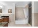Bathroom featuring tiled walls, large tub with shower, and glass-enclosed shower stall at 8150 Southern Pines Dr, Brooksville, FL 34601