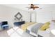 Bright bedroom with a ceiling fan, stylish decor, and a comfortable sitting area at 8150 Southern Pines Dr, Brooksville, FL 34601