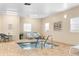 Indoor hot tub in a sunroom with lounge chairs and a gate rules sign at 8150 Southern Pines Dr, Brooksville, FL 34601