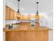 Open kitchen featuring wood cabinets, stone countertops, a breakfast bar, and essential appliances at 8150 Southern Pines Dr, Brooksville, FL 34601