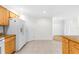 Open kitchen featuring wood cabinets, stone countertops, a breakfast bar, and essential appliances at 8150 Southern Pines Dr, Brooksville, FL 34601