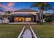 Beautiful backyard with a screened-in patio, lush green lawn, and inviting view; perfect for outdoor relaxation at 1881 Riveredge Dr, Tarpon Springs, FL 34689