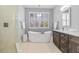 Relaxing bathroom featuring a soaking tub, large windows, stand alone shower, and modern vanity at 1881 Riveredge Dr, Tarpon Springs, FL 34689