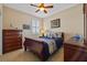 Cozy bedroom with a ceiling fan, neutral walls, and a sleigh bed with ocean-themed decorative pillows at 1881 Riveredge Dr, Tarpon Springs, FL 34689
