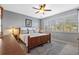 Inviting bedroom with a king-size bed, shuttered windows, and decorative lamps at 1881 Riveredge Dr, Tarpon Springs, FL 34689