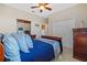 Cozy bedroom with a ceiling fan, closet, and classic decor for a restful and inviting space at 1881 Riveredge Dr, Tarpon Springs, FL 34689