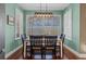Dining room with wood floors, modern light fixture, and plantation shutters for natural light and privacy at 1881 Riveredge Dr, Tarpon Springs, FL 34689