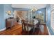 Bright dining room with hardwood floors, chandelier, and a view of the staircase at 1881 Riveredge Dr, Tarpon Springs, FL 34689