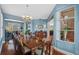 Formal dining room with a large table, a chandelier, and plenty of natural light from the windows at 1881 Riveredge Dr, Tarpon Springs, FL 34689