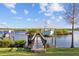 Scenic dock with a boat lift extending into calm waters, perfect for boating and enjoying waterfront living at 1881 Riveredge Dr, Tarpon Springs, FL 34689