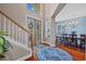 Inviting foyer with hardwood floors, staircase, decorative rug and natural light, creating an elegant entrance at 1881 Riveredge Dr, Tarpon Springs, FL 34689