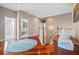 Upstairs hallway with wooden floors and neutral walls at 1881 Riveredge Dr, Tarpon Springs, FL 34689