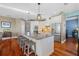Open kitchen featuring a large center island with seating, stainless steel appliances, and hardwood floors at 1881 Riveredge Dr, Tarpon Springs, FL 34689