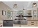 A close-up of the kitchen island featuring a stainless steel farm sink and a modern faucet at 1881 Riveredge Dr, Tarpon Springs, FL 34689