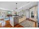 Modern kitchen boasts a large island, stainless steel appliances, and open floorplan at 1881 Riveredge Dr, Tarpon Springs, FL 34689