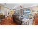 Open-concept living room with hardwood floors, a waterfront view, kitchen, and plush leather seating at 1881 Riveredge Dr, Tarpon Springs, FL 34689