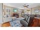 Bright living room with hardwood floors, plantation shutters, and comfortable seating offers a cozy atmosphere at 1881 Riveredge Dr, Tarpon Springs, FL 34689