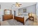 Bright main bedroom featuring a ceiling fan, neutral walls, wood furnishings, and a decorative rug at 1881 Riveredge Dr, Tarpon Springs, FL 34689