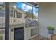 Outdoor kitchen with stainless steel grill and built-in beverage center in screened patio area at 1881 Riveredge Dr, Tarpon Springs, FL 34689