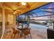 Covered patio dining area with views of the pool and canal at 1881 Riveredge Dr, Tarpon Springs, FL 34689