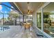 Outdoor living space with screened in patio, pool access, and outdoor kitchen area at 1881 Riveredge Dr, Tarpon Springs, FL 34689
