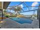 Beautiful screened in pool and hot tub overlooking the water and dock area at 1881 Riveredge Dr, Tarpon Springs, FL 34689