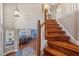 Elegant staircase with wood steps and white railings leading to the upper level of the home at 1881 Riveredge Dr, Tarpon Springs, FL 34689