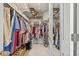 Well-organized walk-in closet with clothing racks, shelving, and ample storage space for shoes and accessories at 1881 Riveredge Dr, Tarpon Springs, FL 34689