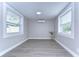 Well-lit room with modern flooring, neutral walls, mini-split air conditioner and updated windows at 245 58Th N St, St Petersburg, FL 33710