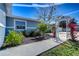Beautifully landscaped yard with flowers and a charming white pergola on a sunny day at 245 58Th N St, St Petersburg, FL 33710