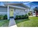 Charming home exterior featuring a bright yellow front door and well-maintained landscaping at 245 58Th N St, St Petersburg, FL 33710