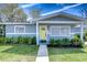 Inviting home exterior with a bright front door, well-maintained lawn, and landscaped garden at 245 58Th N St, St Petersburg, FL 33710