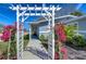 Home's beautiful pathway to entrance, adorned with bougainvillea plants at 245 58Th N St, St Petersburg, FL 33710