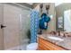 Bathroom featuring a glass-enclosed shower, a marble vanity, and stylish fixtures, creating a modern and functional space at 27045 Firebush Dr, Wesley Chapel, FL 33544