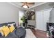 A well decorated bedroom features a unique curved sofa, elephant wall art, and a cozy rug at 27045 Firebush Dr, Wesley Chapel, FL 33544