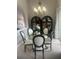 An elegant dining area featuring a glass table, stylish chairs, and a sophisticated chandelier, perfect for memorable meals at 27045 Firebush Dr, Wesley Chapel, FL 33544