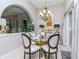 Dining room with a glass table, chandelier, and sliding glass doors at 27045 Firebush Dr, Wesley Chapel, FL 33544