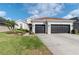 Well-maintained home with a three-car garage, manicured lawn and landscaping at 27045 Firebush Dr, Wesley Chapel, FL 33544