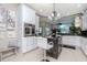 Bright kitchen with white cabinetry, stainless steel appliances, a central island, and a view of the backyard at 27045 Firebush Dr, Wesley Chapel, FL 33544