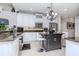 Stylish kitchen featuring granite countertops, white cabinets, and a central island at 27045 Firebush Dr, Wesley Chapel, FL 33544