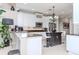 Kitchen featuring white cabinets, granite countertops, a central island with seating, and pendant lighting at 27045 Firebush Dr, Wesley Chapel, FL 33544
