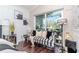 Cozy living room with a striped sofa, dark wood floors and a sliding glass door to the patio at 27045 Firebush Dr, Wesley Chapel, FL 33544