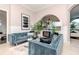 Cozy living room features modern furniture, decorative fireplace, and arched doorways at 27045 Firebush Dr, Wesley Chapel, FL 33544