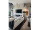 A modern living room with a fireplace, large television, and stylish white sofa, perfect for relaxing and entertaining guests at 27045 Firebush Dr, Wesley Chapel, FL 33544