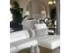 A stylish living room showcasing a white sofa, elegant decor, and a dining area in the background, blending comfort and style at 27045 Firebush Dr, Wesley Chapel, FL 33544