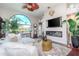 Spacious living area with a large window, fireplace, and modern furnishings at 27045 Firebush Dr, Wesley Chapel, FL 33544